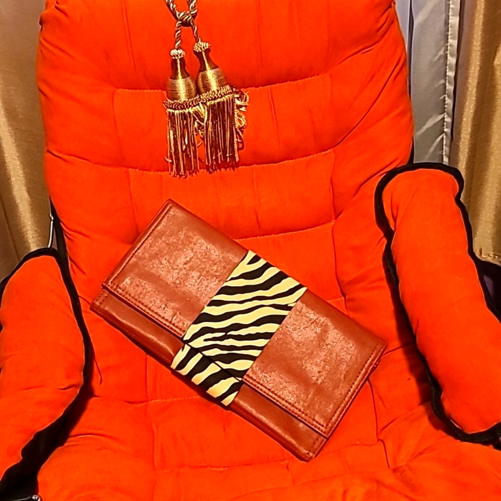Clutch bag. Rust color with zebra material across middle.